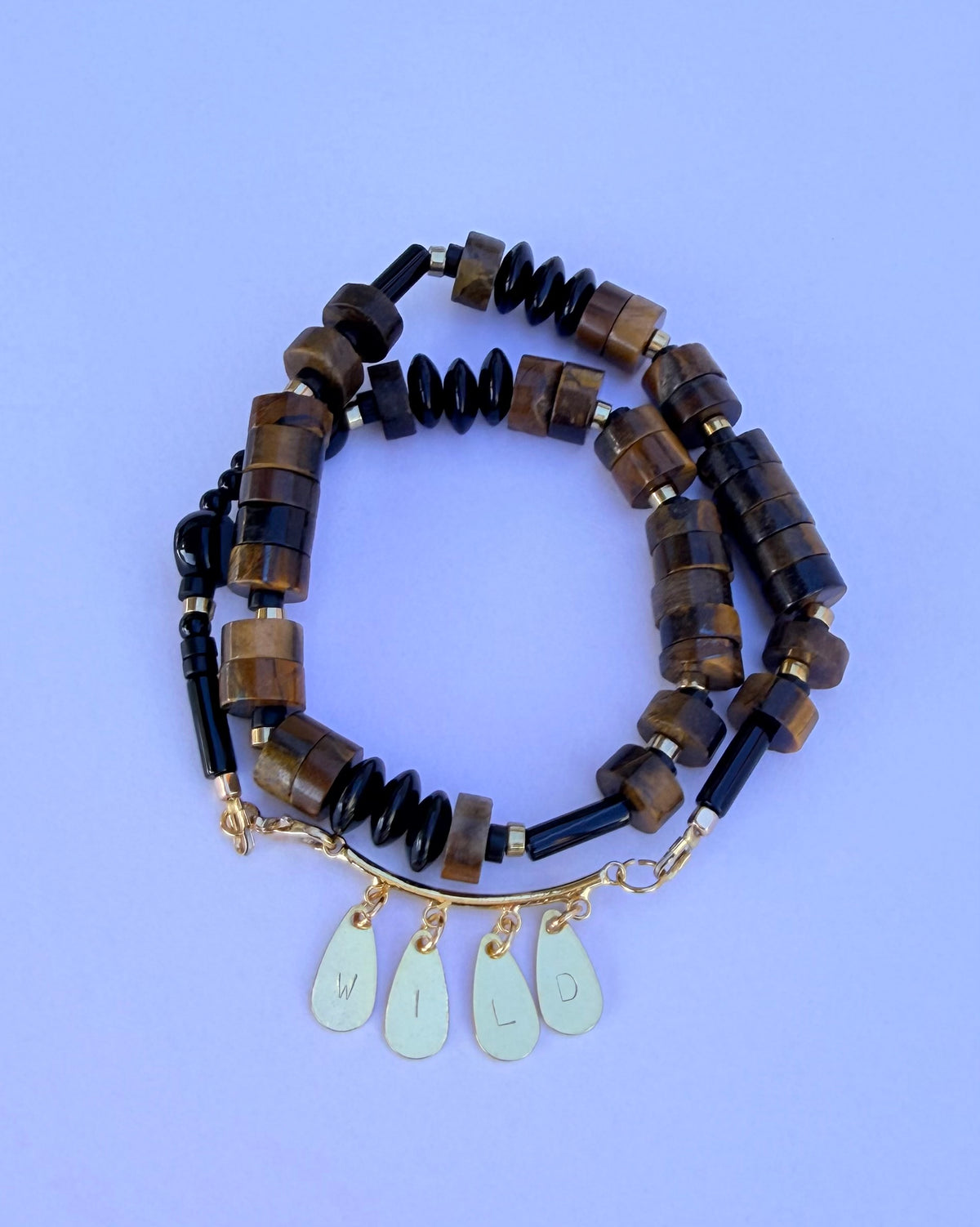 WILD word necklace in tiger's eye and black onyx, hand-stamped letters on 18k gold-plated findings